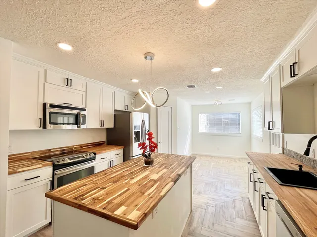 a view of kitchen and hall with wooden floor