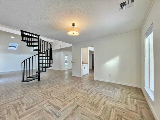 a view of a room with wooden floor and staircase