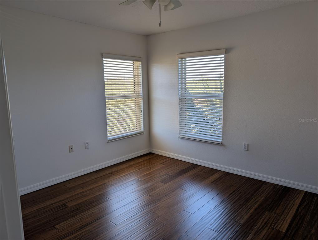 1200 Canopy Walk Lane, Unit 1235 Palm Coast, FL 32137 - Photo 12 of 37 a view of an empty room with wooden floor and a window
