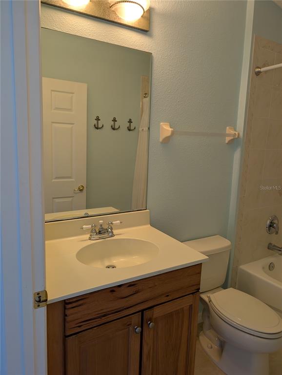 1200 Canopy Walk Lane, Unit 1235 Palm Coast, FL 32137 - Photo 13 of 37 a bathroom with a sink a toilet and shower