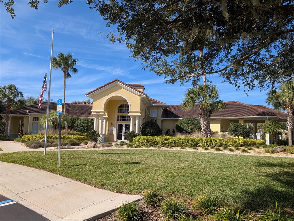 1200 Canopy Walk Lane, Unit 1235 Palm Coast, FL 32137 - Photo 16 of 37 a front view of a house with garden