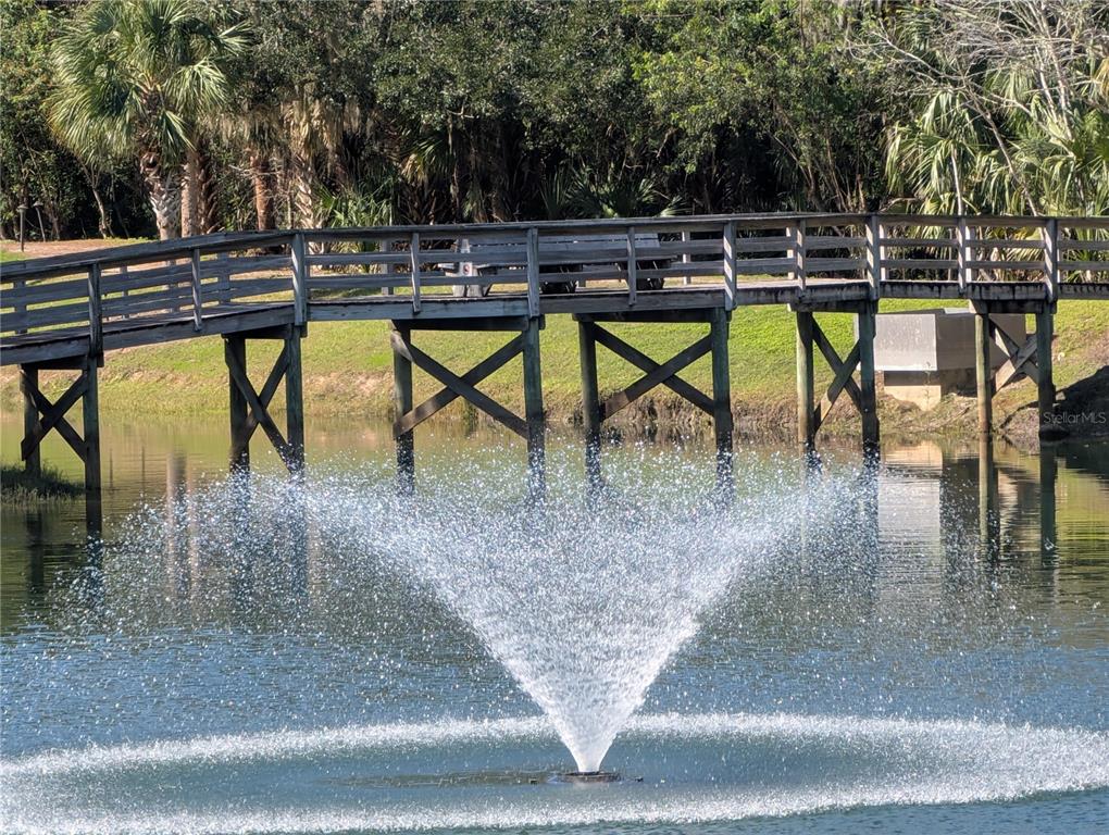 1200 Canopy Walk Lane, Unit 1235 Palm Coast, FL 32137 - Photo 34 of 37 a view of a swimming pool with a table and chairs