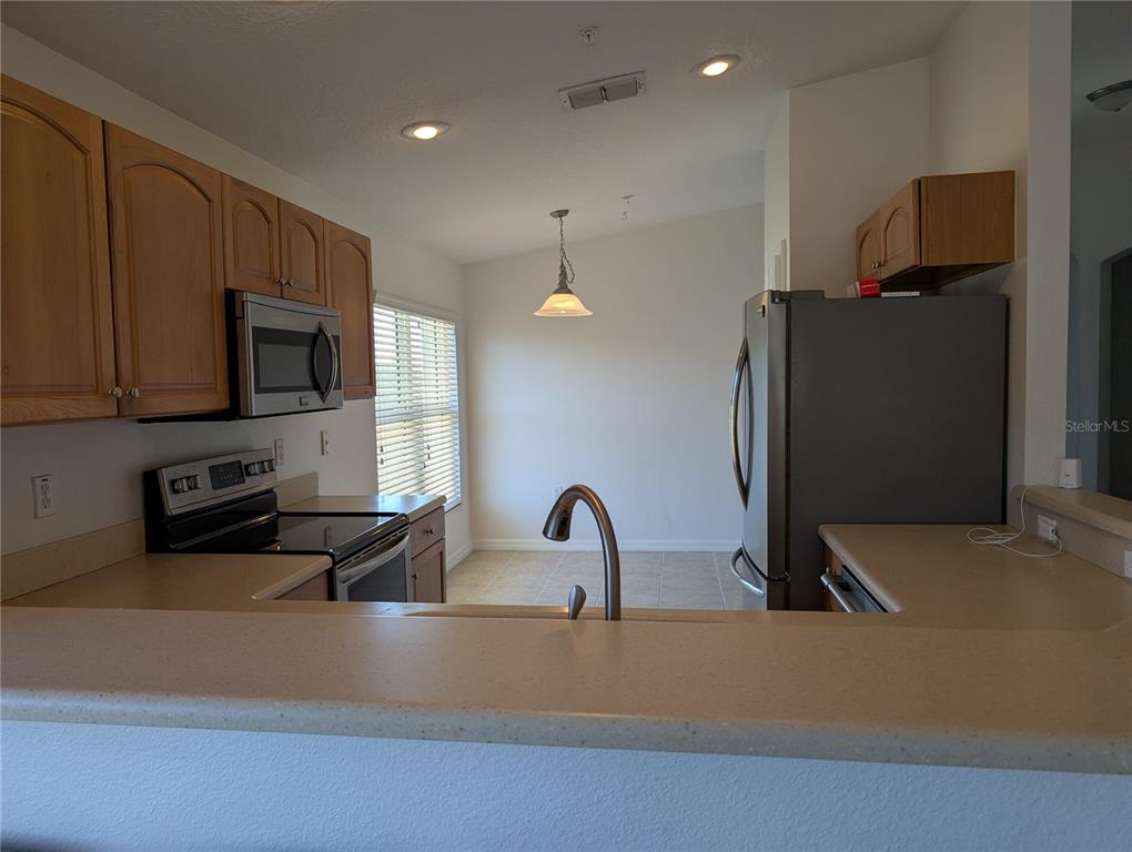 1200 Canopy Walk Lane, Unit 1235 Palm Coast, FL 32137 - Photo 6 of 37 a kitchen with a sink and a refrigerator