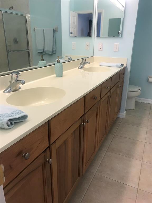 1200 Canopy Walk Lane, Unit 1235 Palm Coast, FL 32137 - Photo 10 of 37 a bathroom with a double vanity sink and a mirror