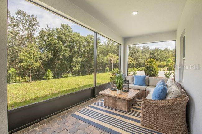 16492 Crane Road Weeki Wachee, FL 34614 - Photo 21 of 24 a living room with furniture and floor to ceiling windows