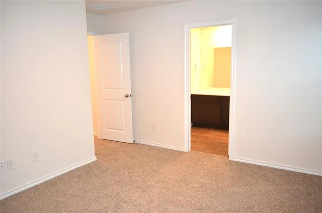 a view of an empty room with a closet