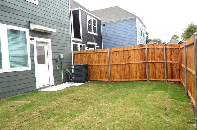 a view of a backyard with a wooden fence