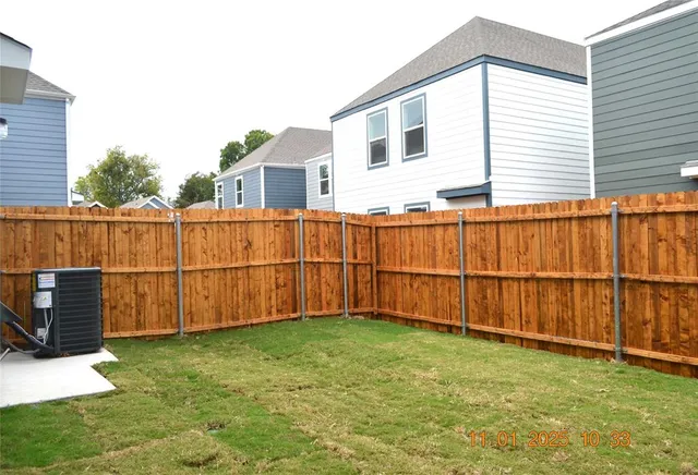 a view of a backyard with a fence