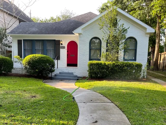 a view of a house with swimming pool and a yard