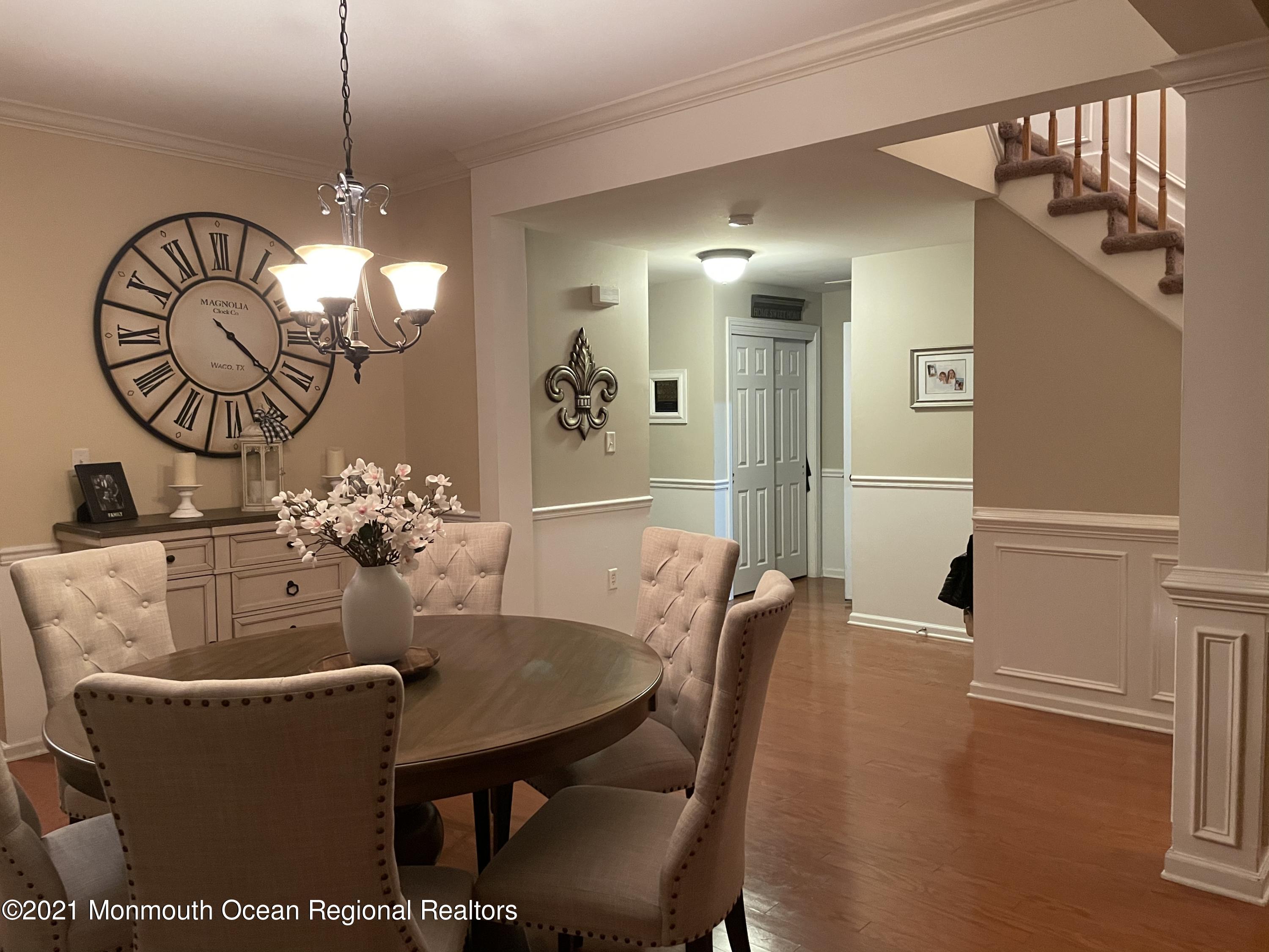 39 Springhouse Circle Manalapan, NJ 07726 - Photo 3 of 78 a dining room with furniture a chandelier and wooden floor