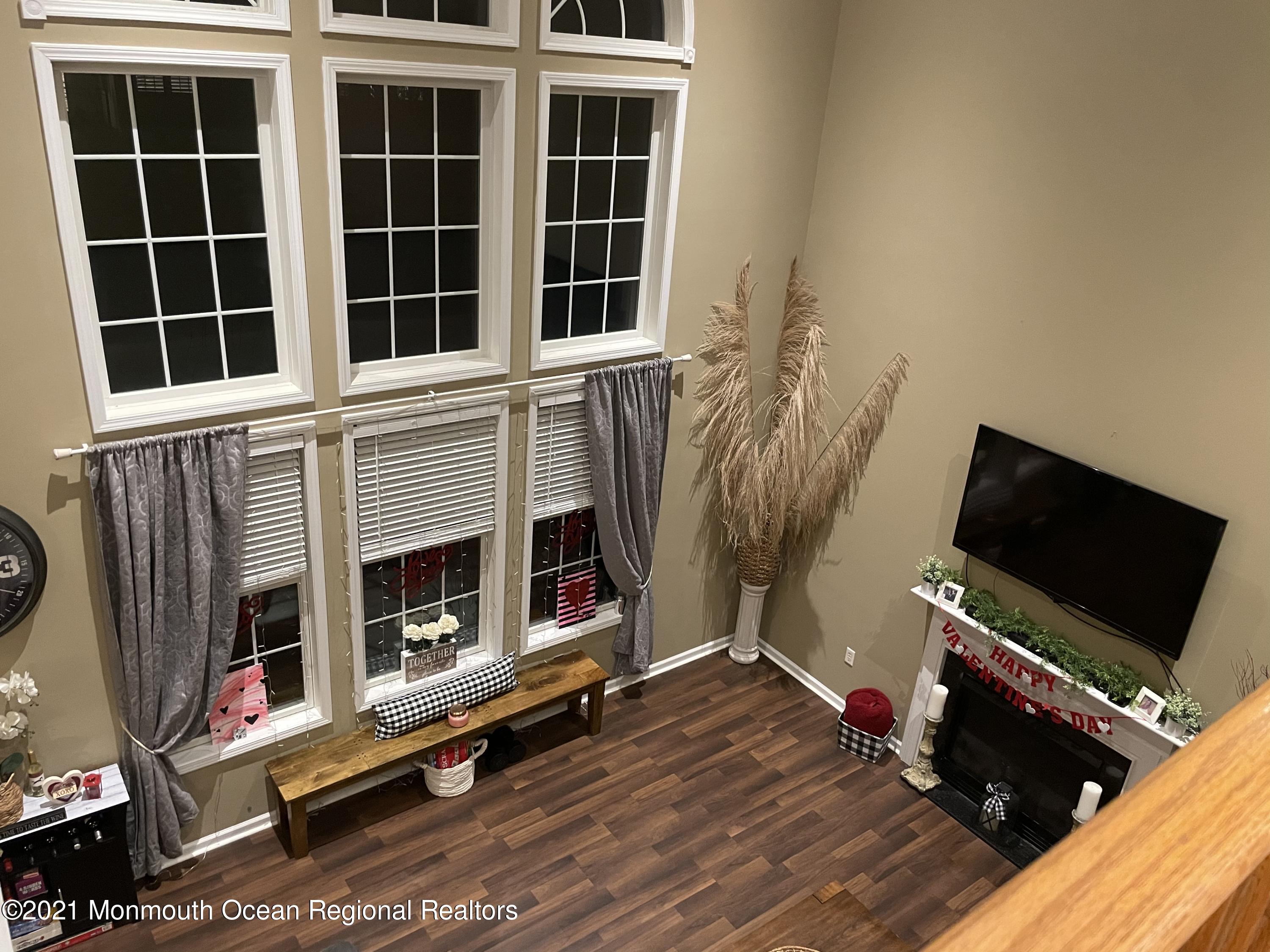 39 Springhouse Circle Manalapan, NJ 07726 - Photo 22 of 78 a view of an empty room with wooden floor and a window