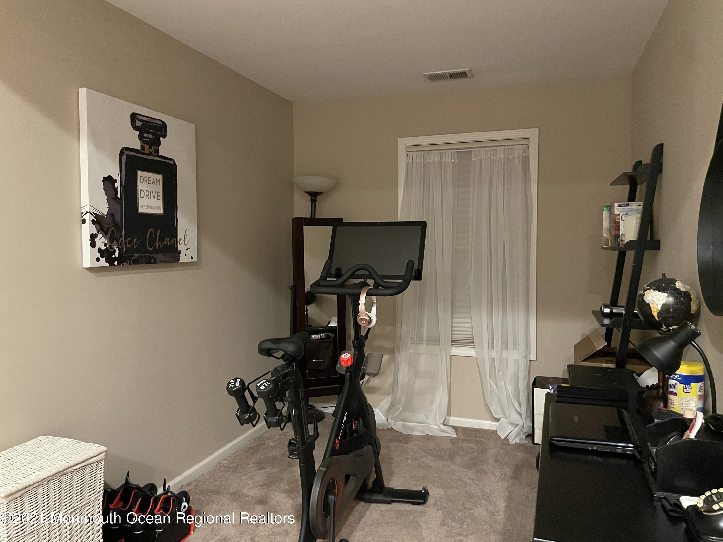 39 Springhouse Circle Manalapan, NJ 07726 - Photo 40 of 78 a view of a room with gym equipment