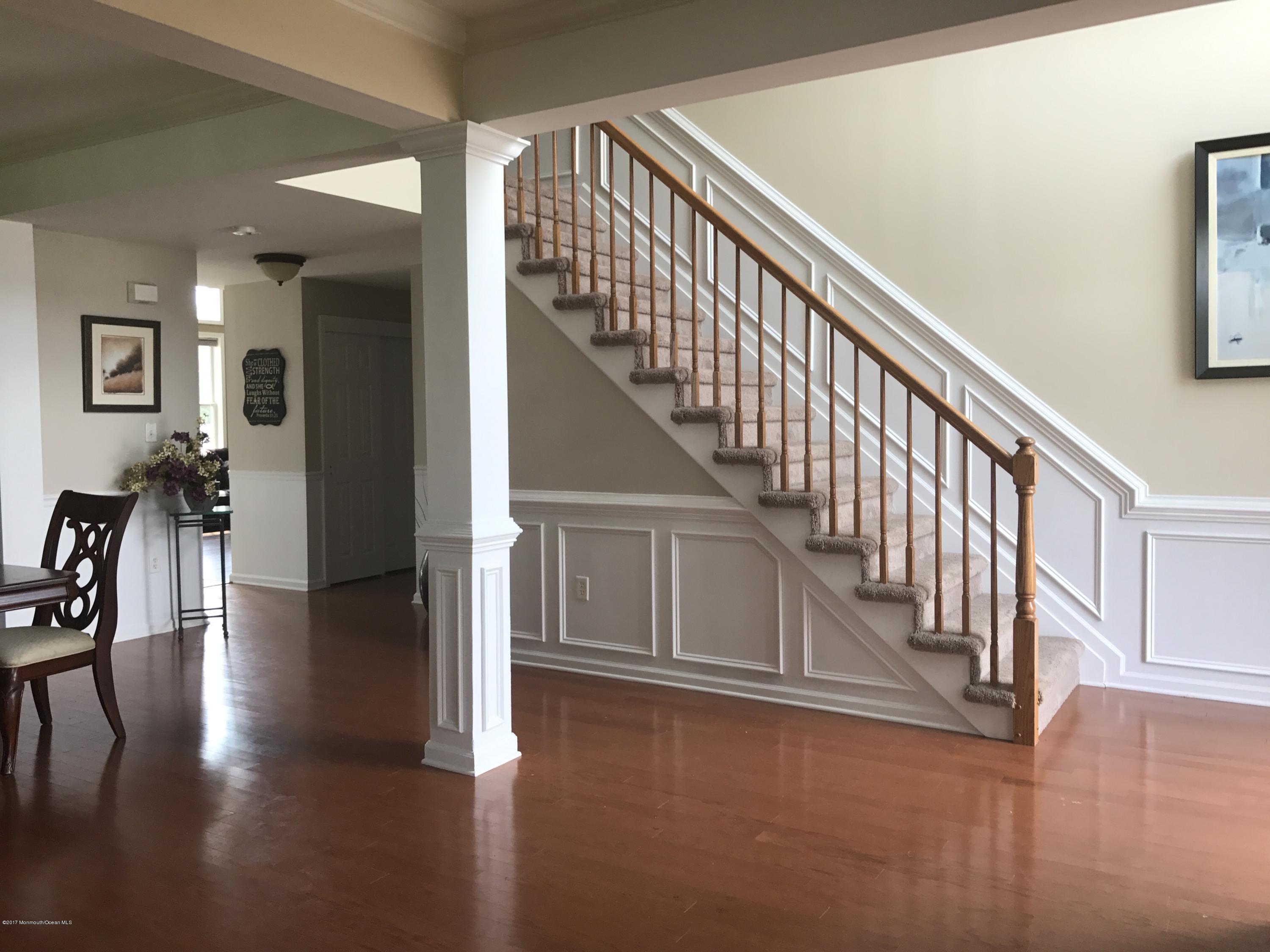 39 Springhouse Circle Manalapan, NJ 07726 - Photo 8 of 78 a view of entryway and hall with wooden floor