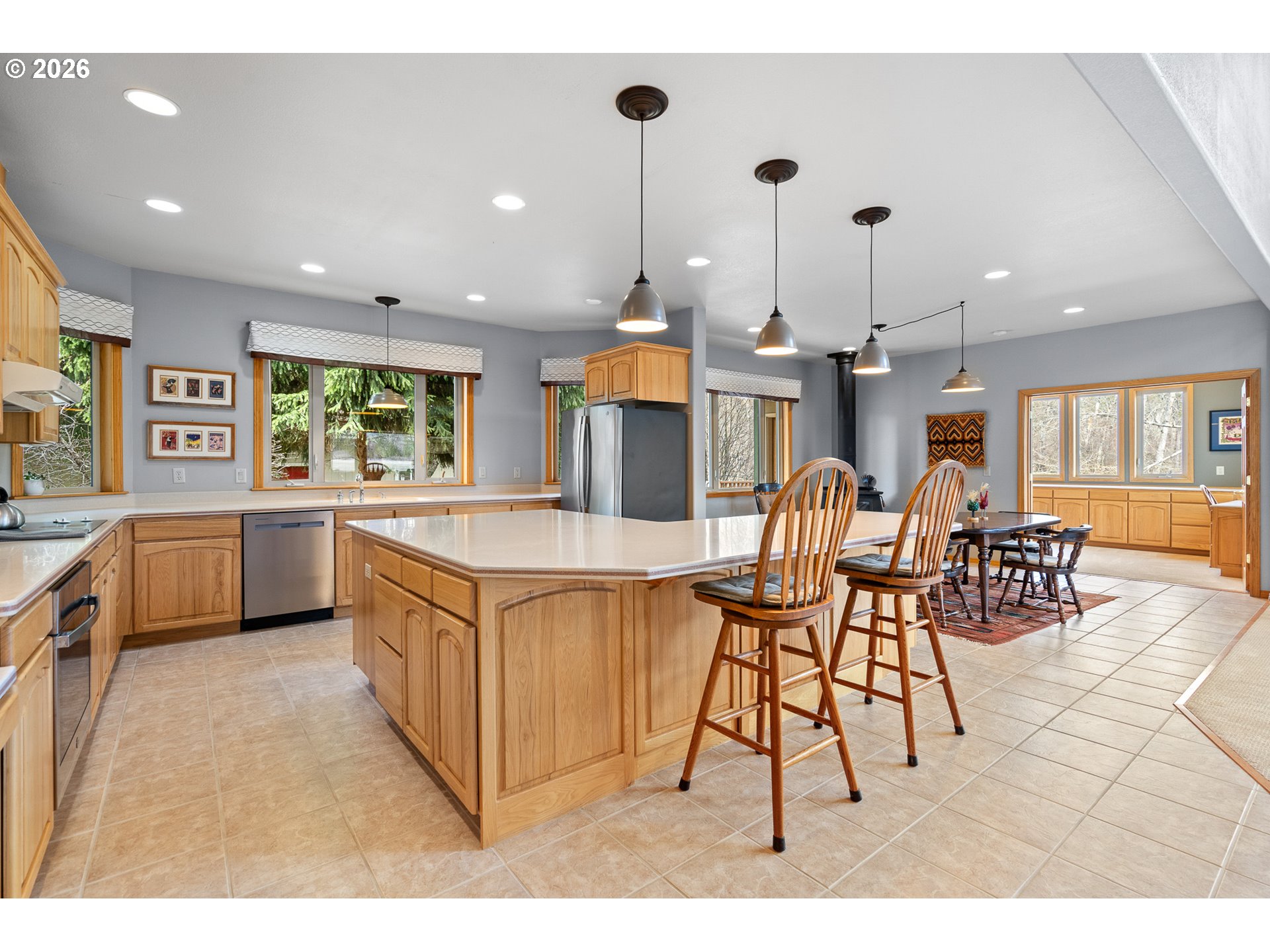 54693 Bingham Road Adams, OR 97810 - Photo 21 of 48 a kitchen with stainless steel appliances kitchen island granite countertop a table chairs and a view of living room