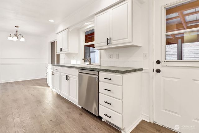 a kitchen with stainless steel appliances granite countertop a sink and cabinets