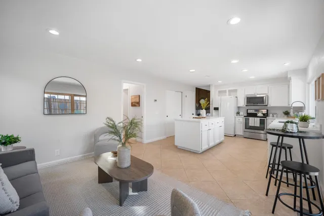 a view of washer and dryer with kitchen in the background