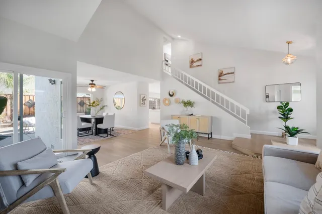 a living room with furniture and wooden floor