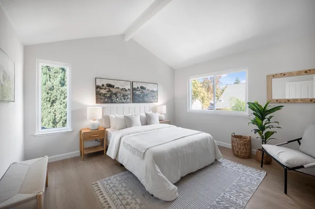 a bedroom with a bed and a potted plant