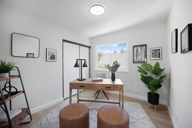 a bedroom with a bed and a painting on the wall