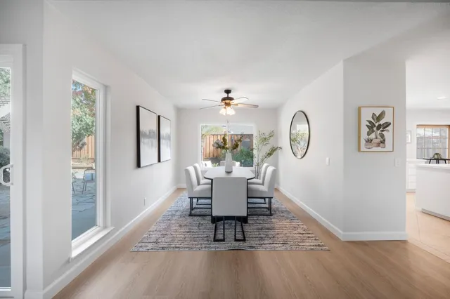 a view of a dining room with furniture window and wooden floor
