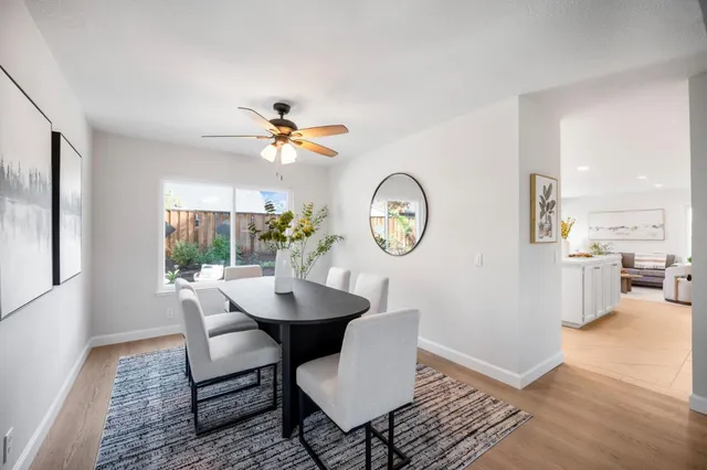 a view of a dining room with furniture and chandelier