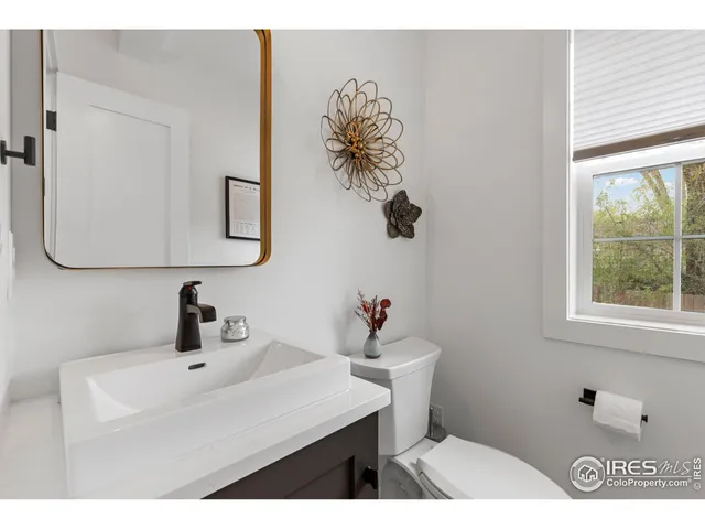 a bathroom with a sink a mirror and a toilet