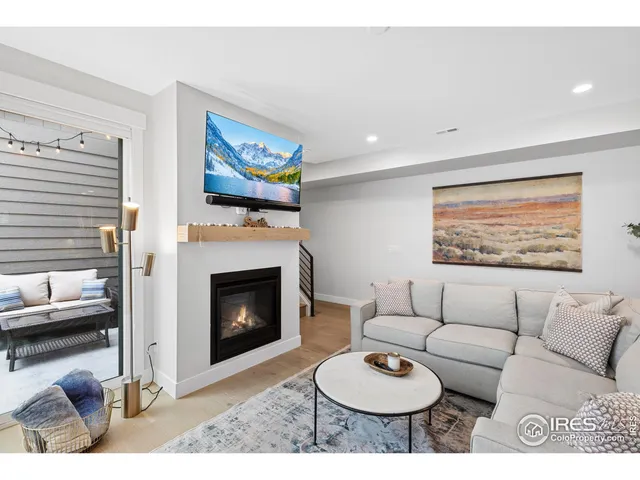 a living room with furniture a fireplace with wooden floor