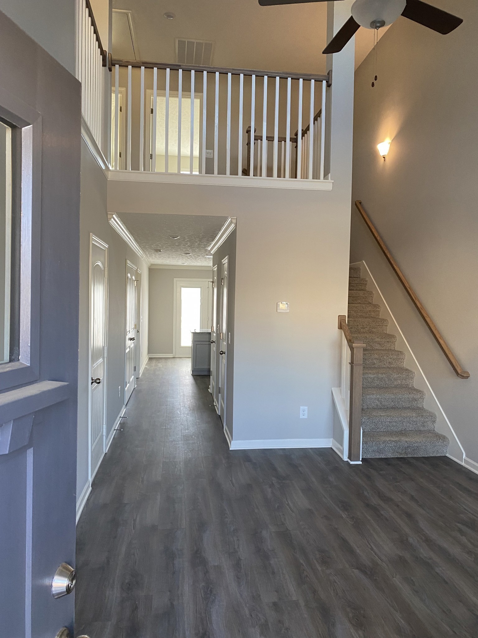 130 Rising Lane, Unit 130 Gallatin, TN 37066 - Photo 3 of 8 a view of staircase with lots of frames on wall and wooden floor