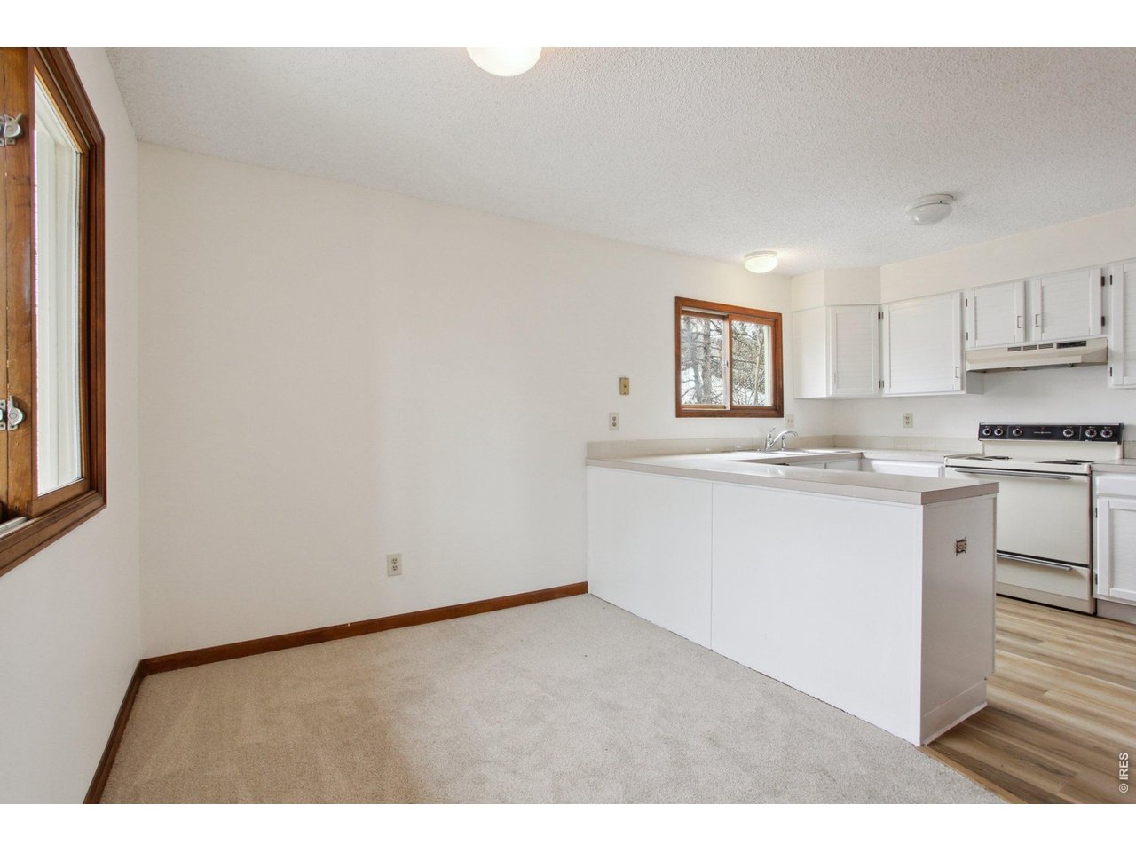 2651 9th Street Boulder, CO 80304 - Photo 4 of 25 a kitchen with granite countertop white cabinets and white appliances