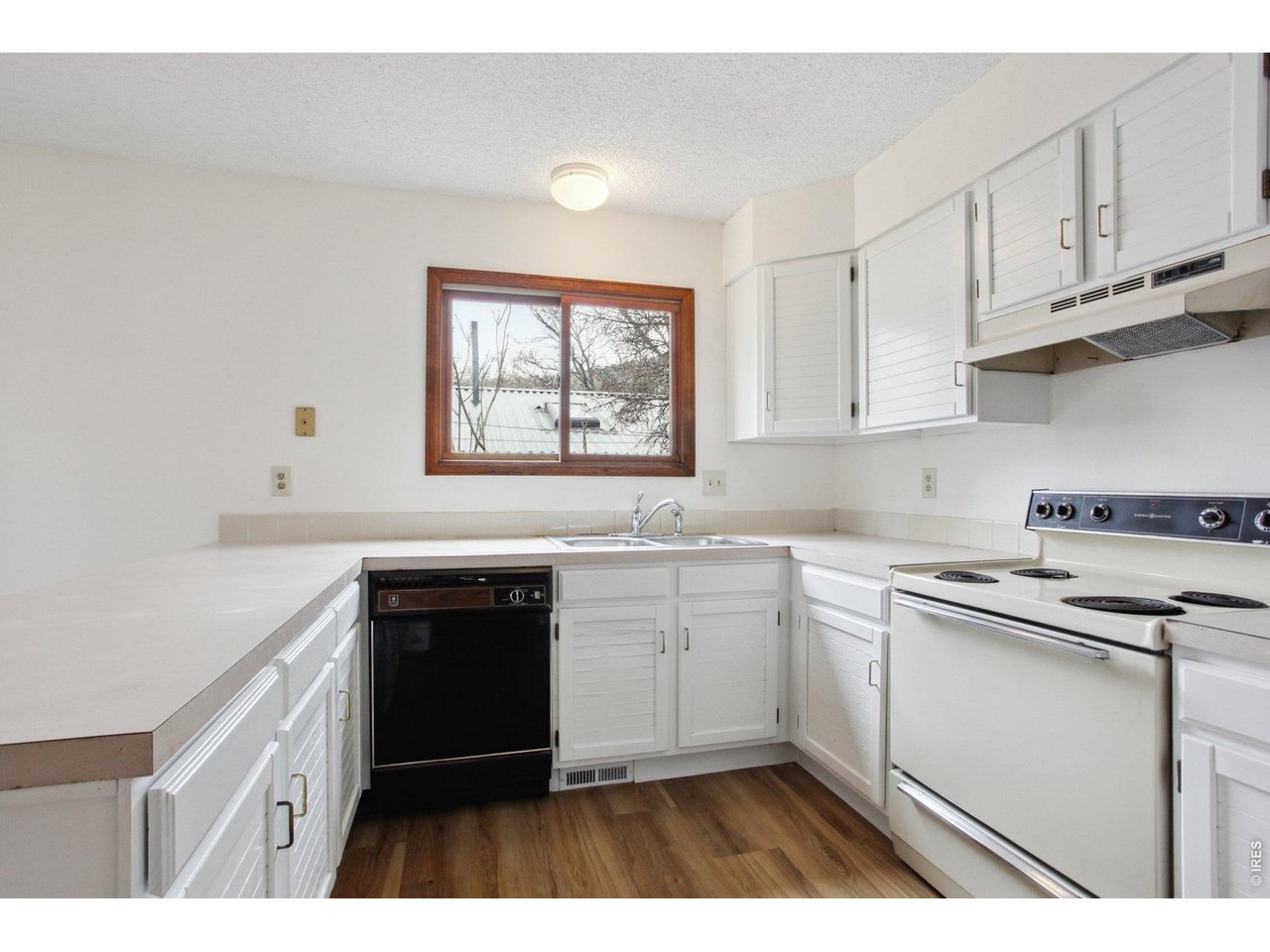 2651 9th Street Boulder, CO 80304 - Photo 6 of 25 a kitchen with stainless steel appliances granite countertop a stove a sink and white cabinets