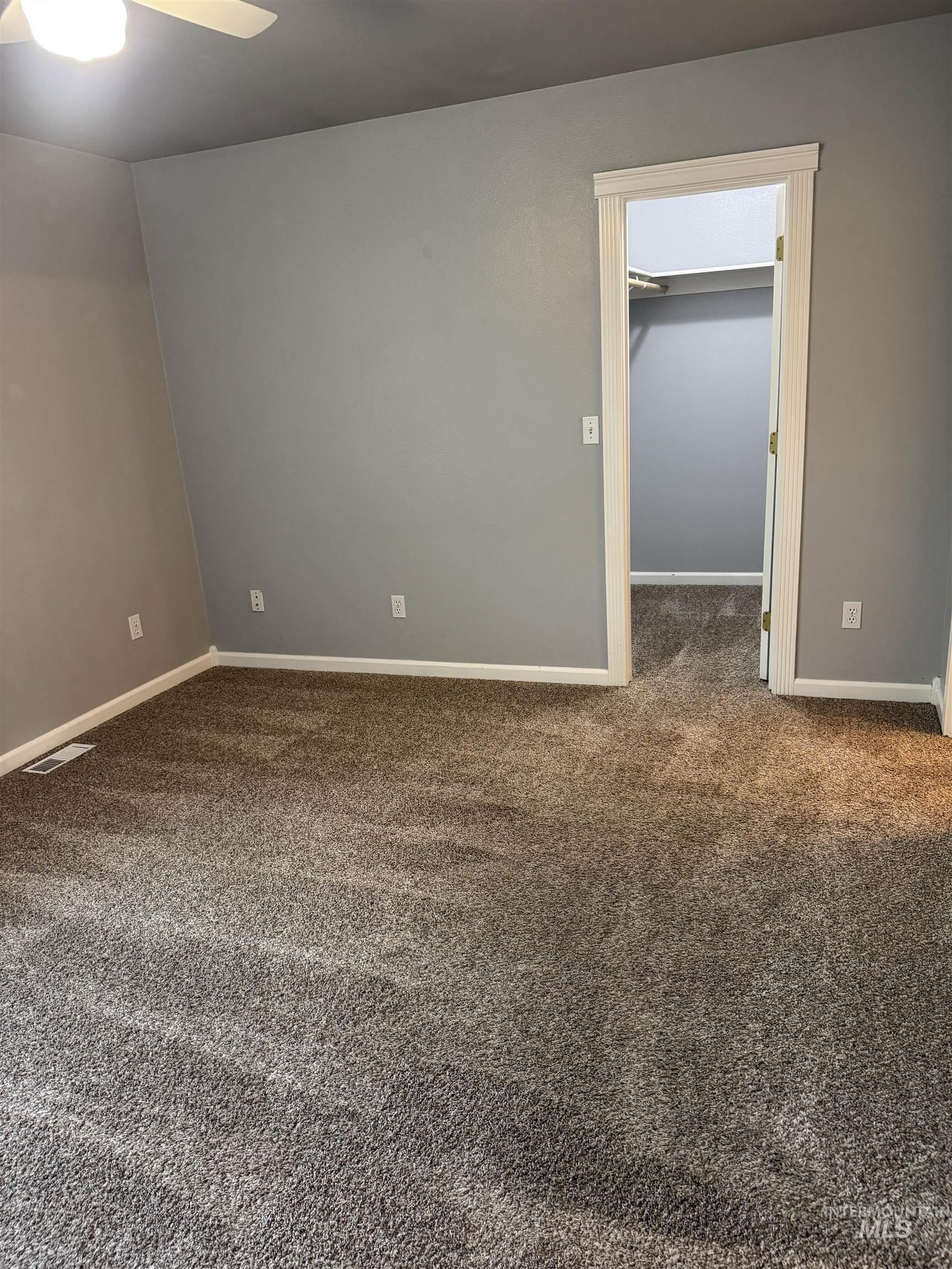 3203 South Capistrano Avenue Boise, ID 83705 - Photo 12 of 30 Empty room with dark colored carpet and ceiling fan