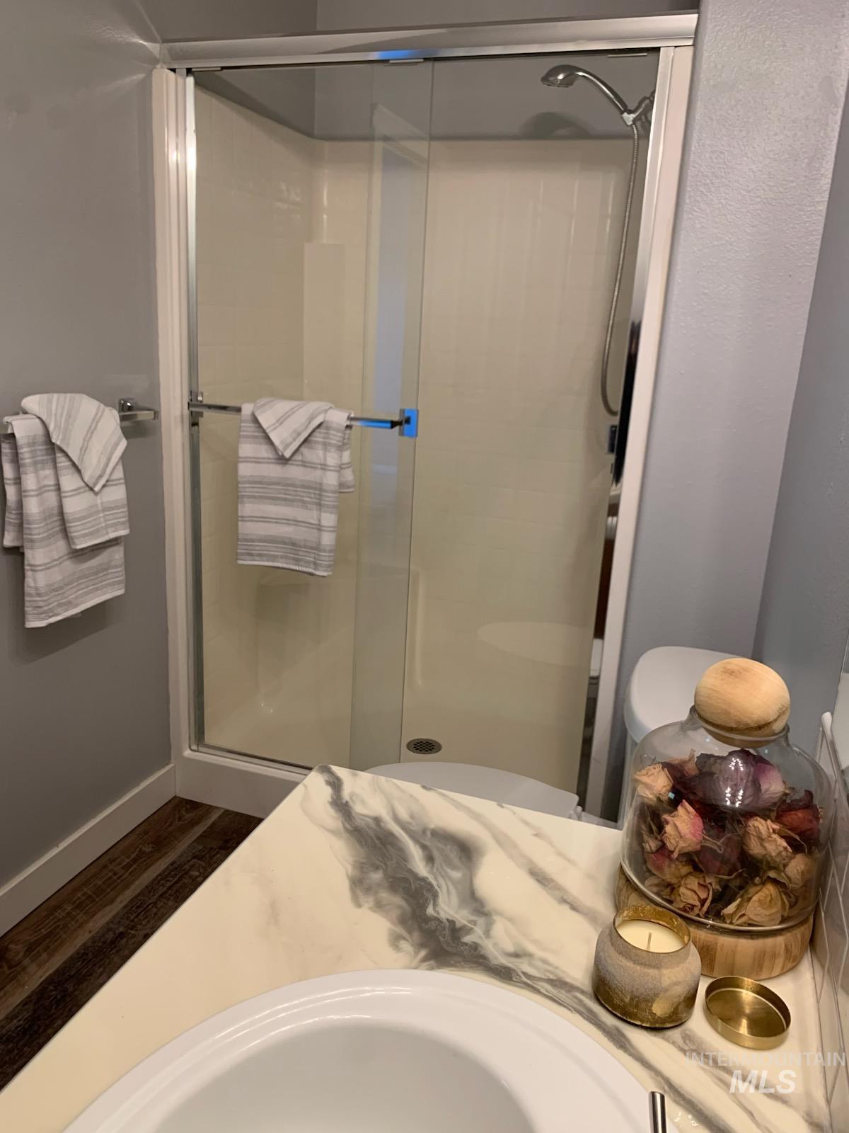 3203 South Capistrano Avenue Boise, ID 83705 - Photo 19 of 30 Bathroom with a shower stall, dark wood-style floors, and vanity