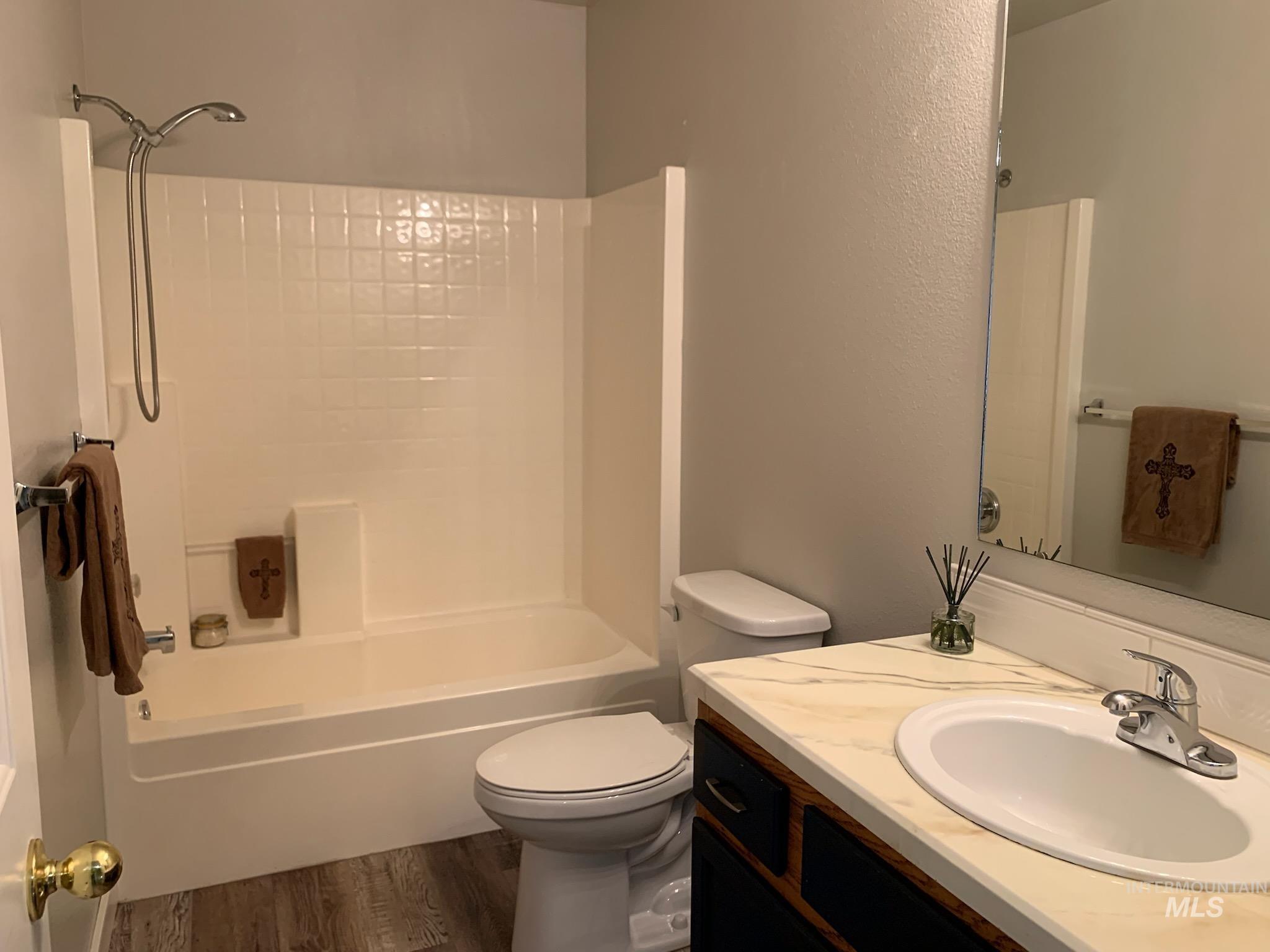 3203 South Capistrano Avenue Boise, ID 83705 - Photo 21 of 30 Full bathroom featuring vanity, wood finished floors, and shower combination