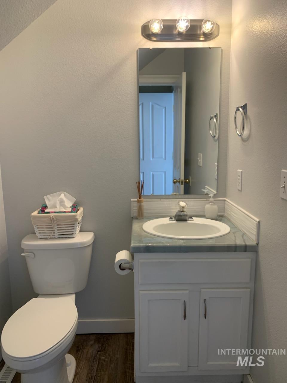 3203 South Capistrano Avenue Boise, ID 83705 - Photo 23 of 30 Half bath with a textured wall, vanity, and dark wood-style flooring