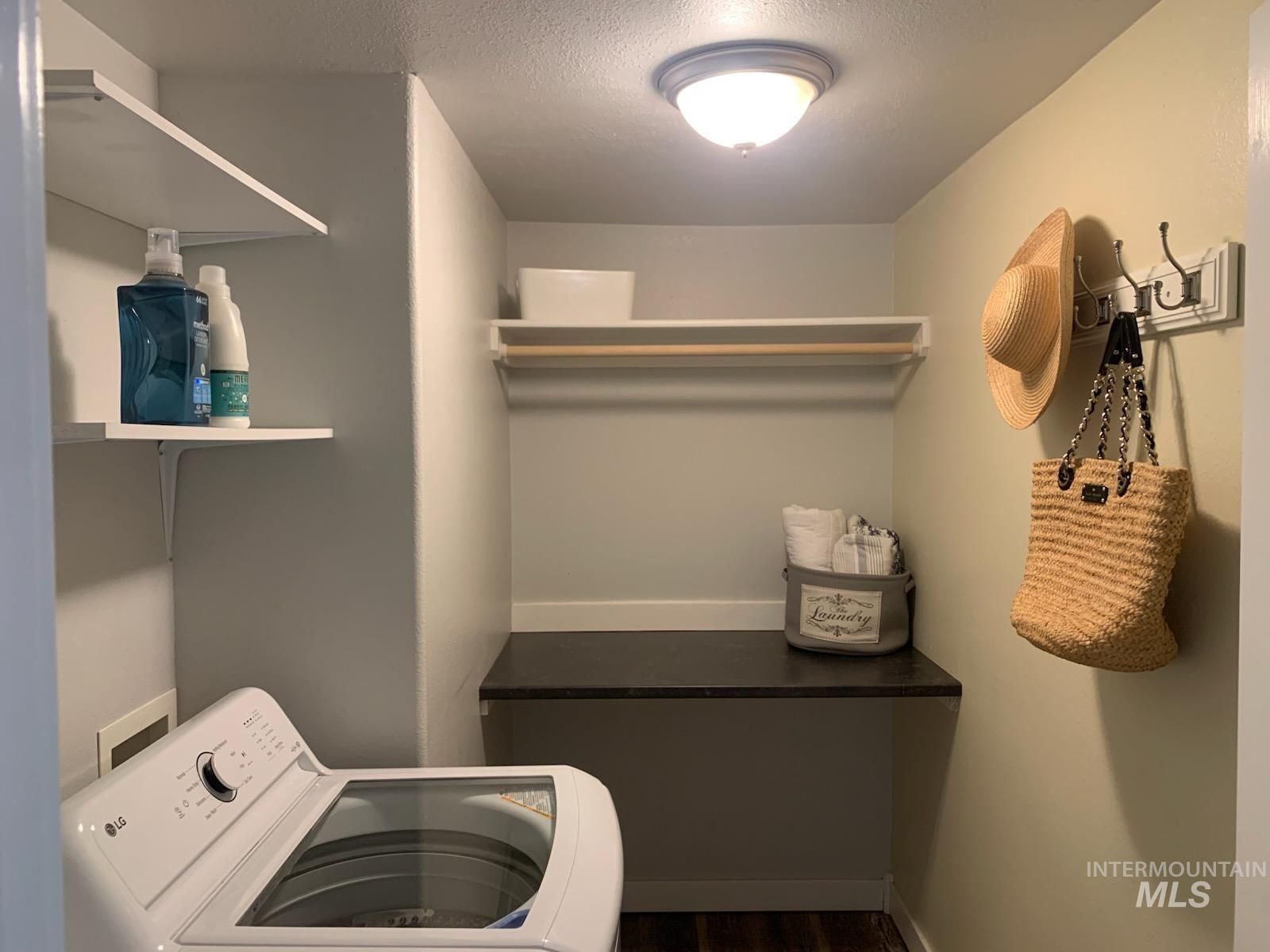 3203 South Capistrano Avenue Boise, ID 83705 - Photo 25 of 30 Laundry area featuring washer / dryer, dark wood-style floors, and a textured ceiling