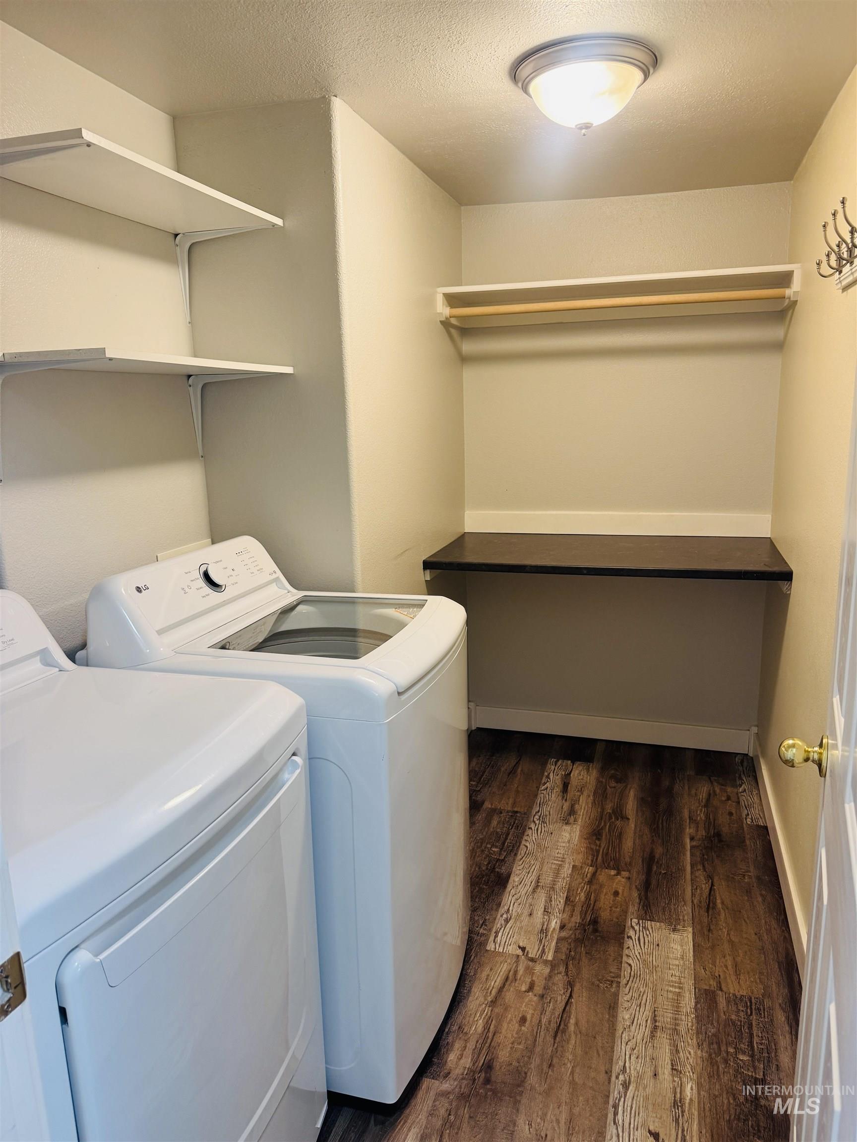 3203 South Capistrano Avenue Boise, ID 83705 - Photo 26 of 30 Laundry area featuring dark wood-type flooring, washing machine and dryer, and a textured ceiling