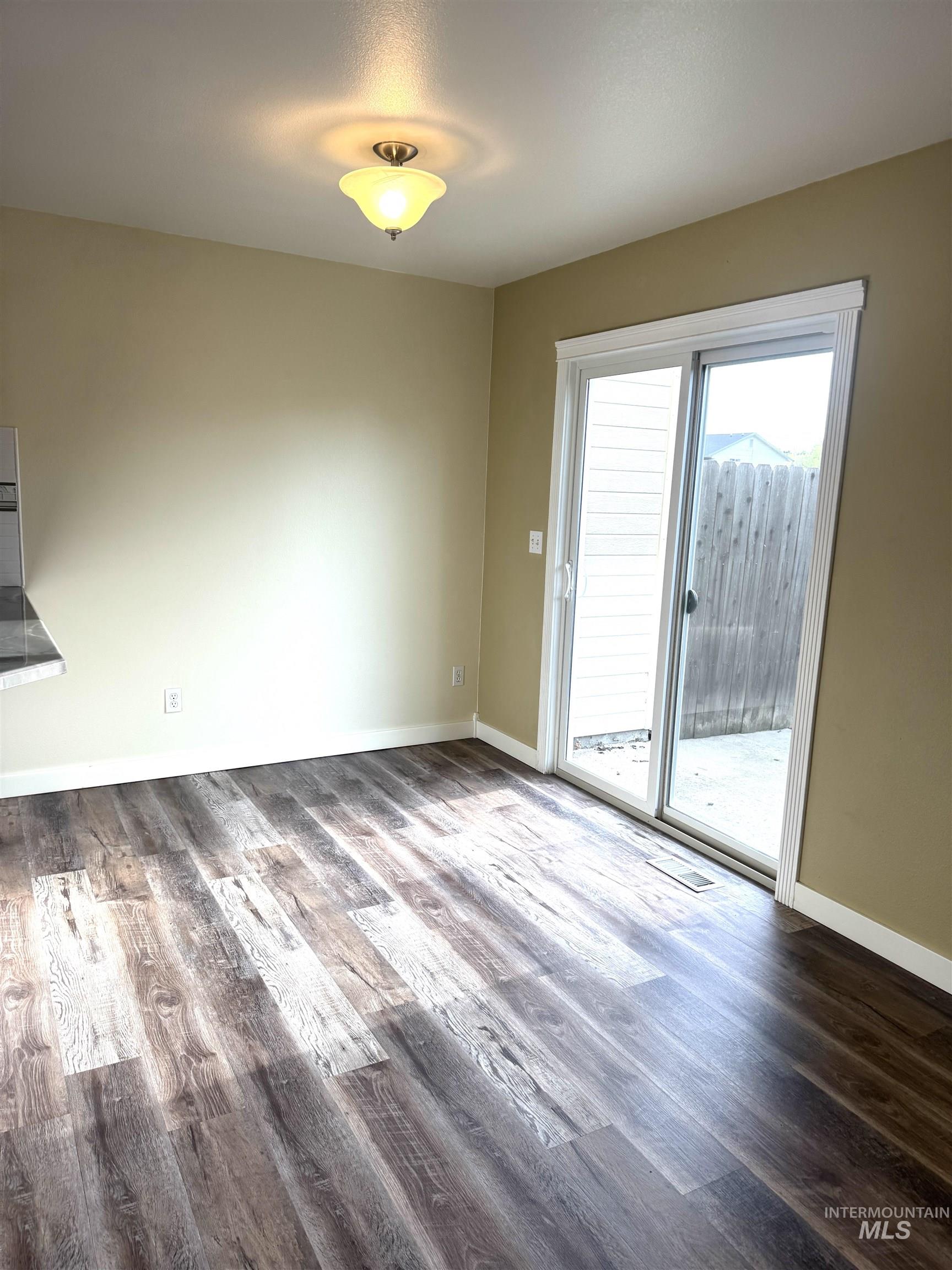 3203 South Capistrano Avenue Boise, ID 83705 - Photo 7 of 30 Unfurnished dining area featuring dark wood-type flooring