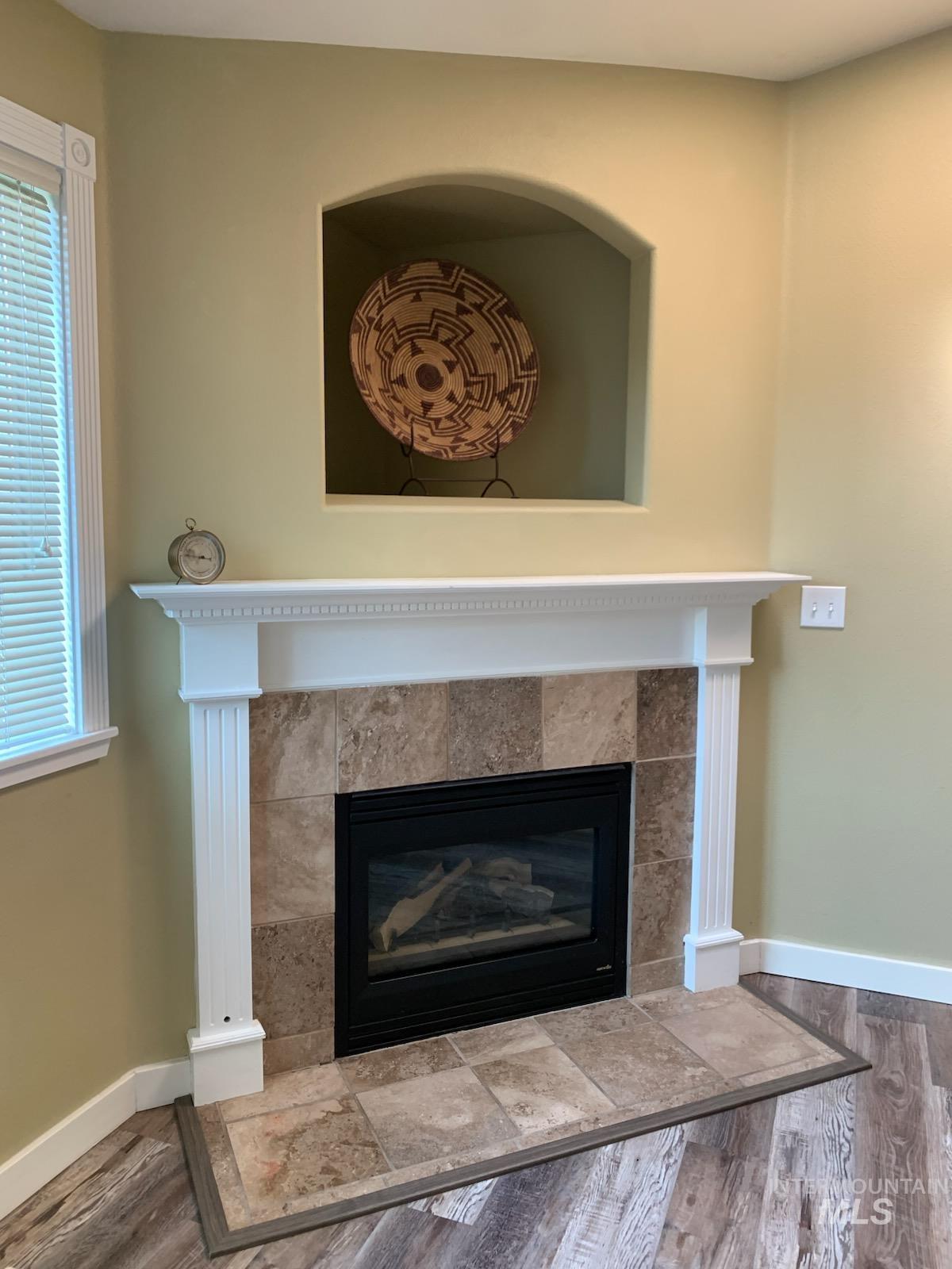 3203 South Capistrano Avenue Boise, ID 83705 - Photo 8 of 30 Detailed view of a fireplace and wood finished floors