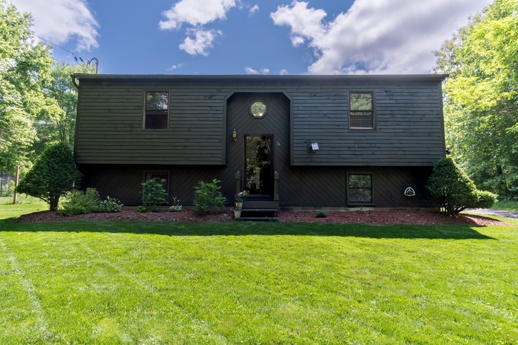76 River Road Ware, MA 01082 - Photo 1 of 30 a front view of a house with patio and garden
