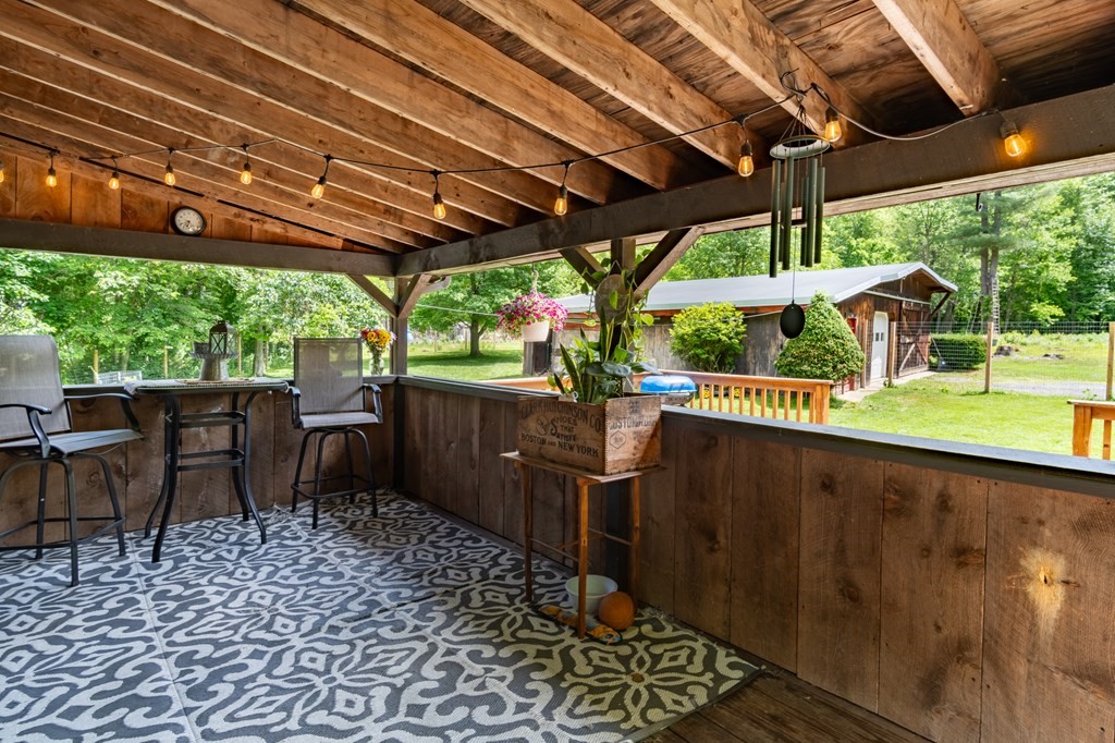 76 River Road Ware, MA 01082 - Photo 16 of 30 a view of a patio with table and chairs under an umbrella