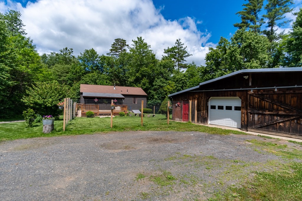 76 River Road Ware, MA 01082 - Photo 20 of 30 a house with trees in the background