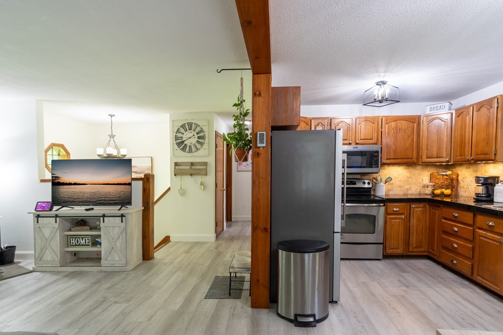 76 River Road Ware, MA 01082 - Photo 4 of 30 a kitchen with stainless steel appliances granite countertop a refrigerator stove and microwave