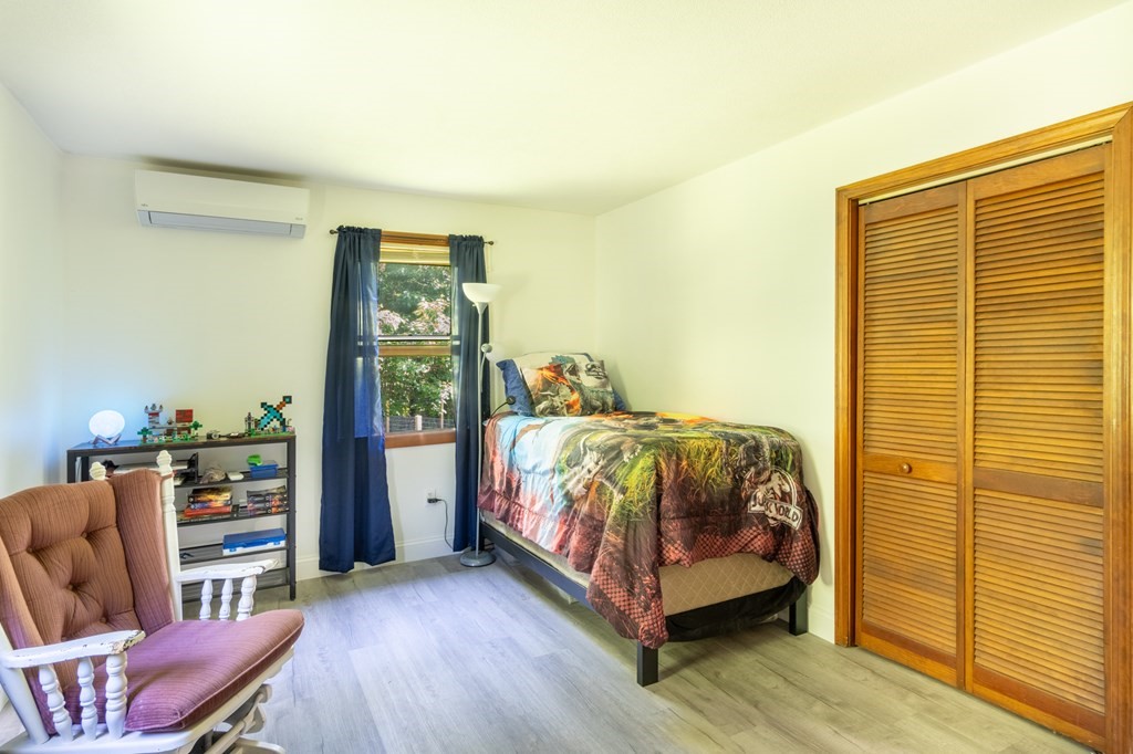 76 River Road Ware, MA 01082 - Photo 9 of 30 a bedroom with a bed and wooden floor