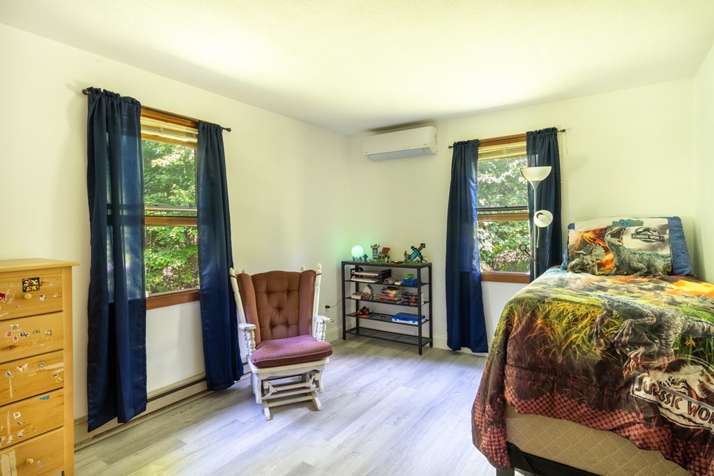 76 River Road Ware, MA 01082 - Photo 10 of 30 a bedroom with a bed and wooden floor