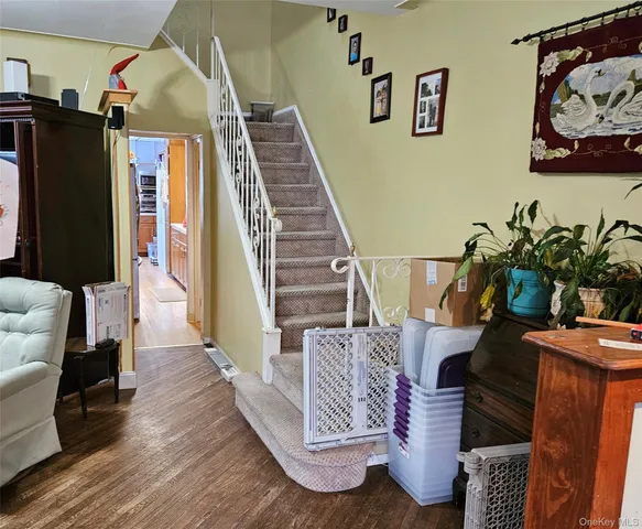 a utility room with wooden floor washer and dryer
