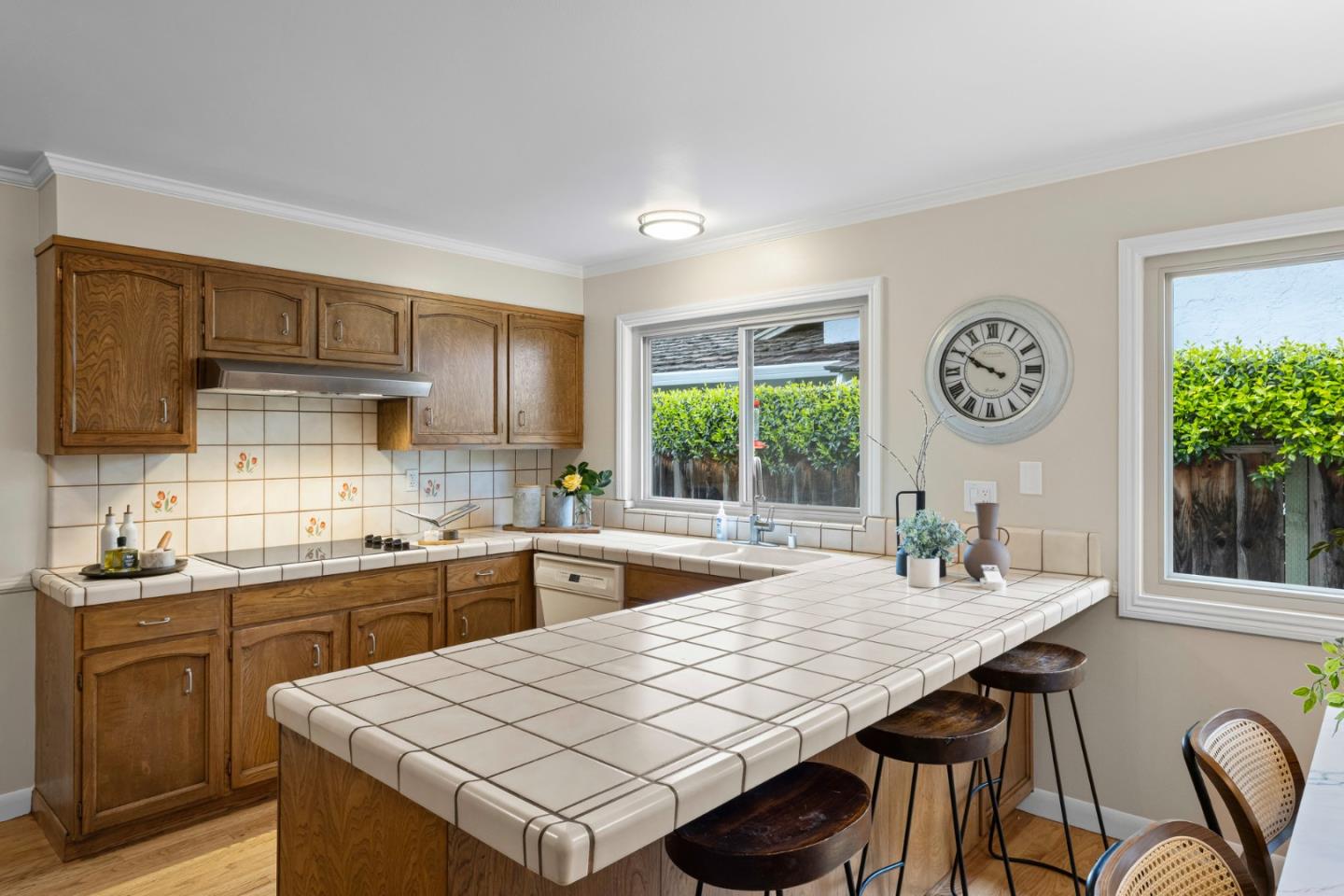 2356 Walden Square San Jose, CA 95124 - Photo 28 of 51 a kitchen with a stove a sink dishwasher a dining table and chairs with wooden floor