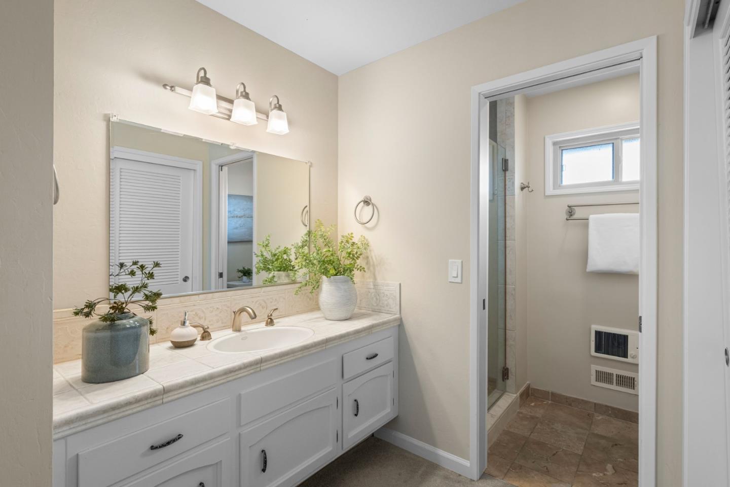 2356 Walden Square San Jose, CA 95124 - Photo 35 of 51 a bathroom with double vanity sinks a vanity a lamp and a mirror