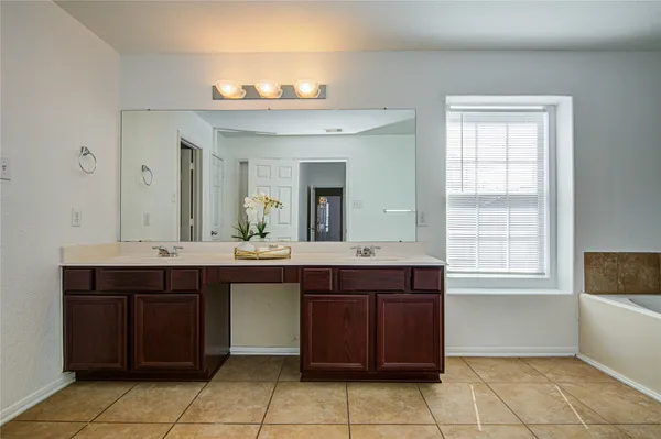 a spacious bathroom with a sink and a mirror