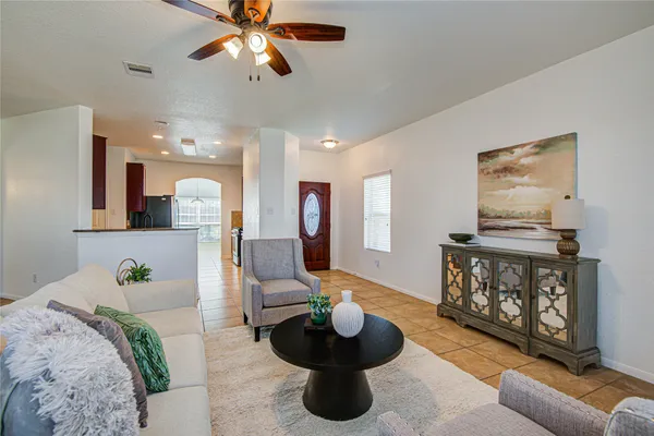 a living room with furniture and a wooden floor