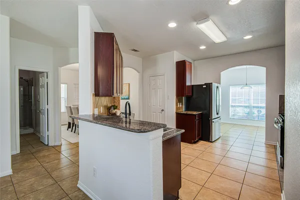 a kitchen with stainless steel appliances a sink and a refrigerator